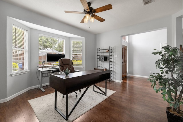 office featuring ceiling fan, dark wood finished floors, and baseboards