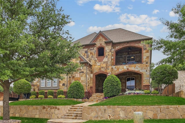 603 Comal Ct, Keller, TX 76248 - tudor-style house featuring a balcony, stone siding, and a shingled roof