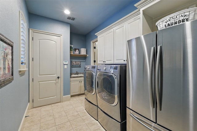 603 Comal Ct, Keller, TX 76248 - clothes washing area featuring baseboards, cabinet space, separate washer and dryer, and light tile patterned floors