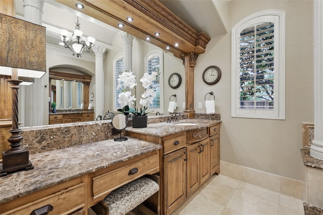 603 Comal Ct, Keller, TX 76248 - bathroom featuring decorative columns, tile patterned floors, vanity, baseboards, and a chandelier