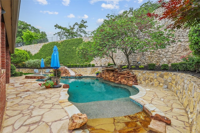603 Comal Ct, Keller, TX 76248 - view of swimming pool with a patio, a water slide, a fenced backyard, and an in-ground hot tub