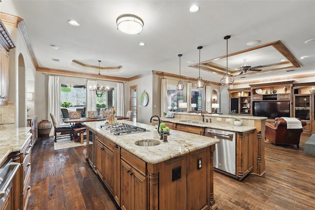 603 Comal Ct, Keller, TX 76248 - kitchen featuring a tray ceiling, appliances with stainless steel finishes, a sink, arched walkways, and a spacious island