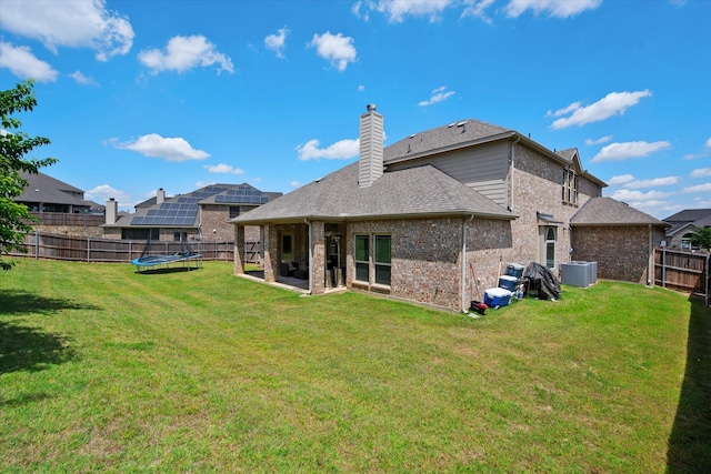 3449 Ava Dr, Midlothian, TX 76065 - back of house featuring a trampoline, brick siding, a chimney, cooling unit, and a patio