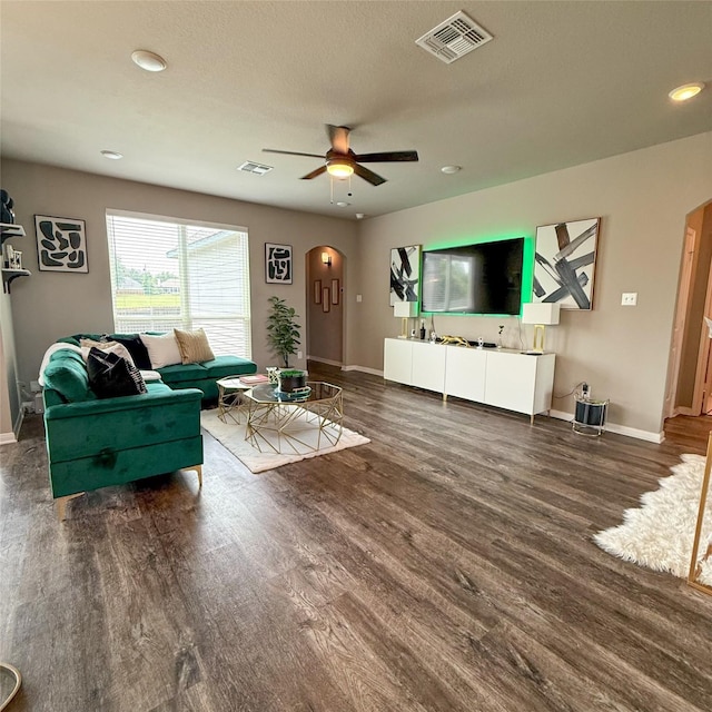 5202 Fallen Tree Dr, Temple, TX 76502 - living room with arched walkways, wood finished floors, ceiling fan, baseboards, and recessed lighting