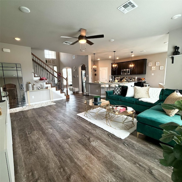 5202 Fallen Tree Dr, Temple, TX 76502 - living area with arched walkways, wood finished floors, stairway, a ceiling fan, and recessed lighting