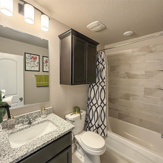 5202 Fallen Tree Dr, Temple, TX 76502 - bathroom featuring a textured ceiling, toilet, shower / bath combo with shower curtain, vanity, and a textured wall