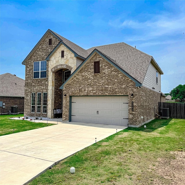 5202 Fallen Tree Dr, Temple, TX 76502 - view of front of home with brick siding, concrete driveway, a garage, and central AC