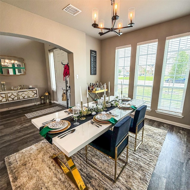 5202 Fallen Tree Dr, Temple, TX 76502 - dining room with a chandelier, arched walkways, wood finished floors, and baseboards