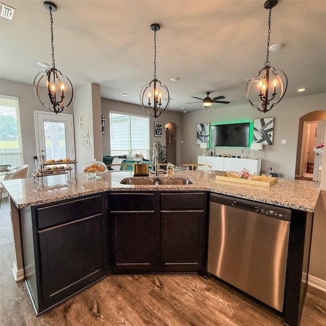 5202 Fallen Tree Dr, Temple, TX 76502 - kitchen featuring stainless steel dishwasher, arched walkways, a sink, open floor plan, and recessed lighting