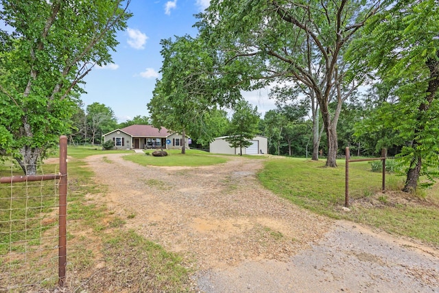 7909 W Fm 1753, Ravenna, TX 75476 - view of grassy yard featuring dirt driveway, an outbuilding, and a garage