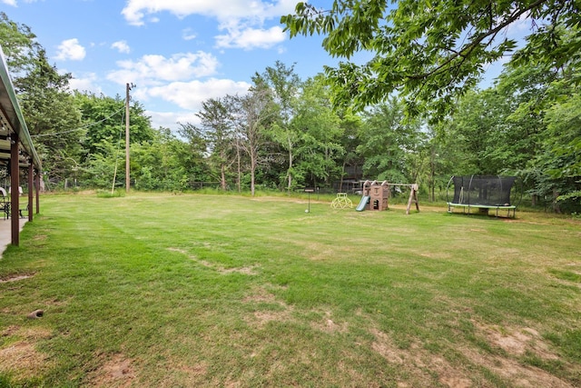 7909 W Fm 1753, Ravenna, TX 75476 - view of grassy yard featuring a trampoline and a playground