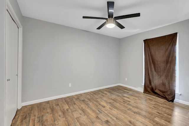 10240 Regal Oaks Dr Unit C, Dallas, TX 75230 - unfurnished bedroom featuring wood finished floors, baseboards, a closet, and a ceiling fan