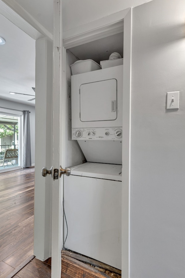 10240 Regal Oaks Dr Unit C, Dallas, TX 75230 - laundry room featuring estacked washer and dryer and wood finished floors