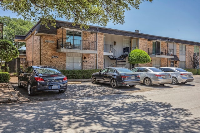 10240 Regal Oaks Dr Unit C, Dallas, TX 75230 - view of property featuring uncovered parking and stairway