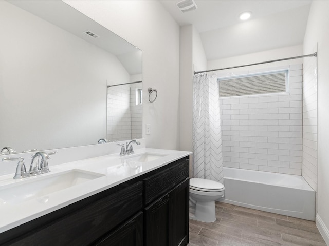 6020 Paddock Ln, Little Elm, TX 76227 - bathroom featuring double vanity, toilet, shower / bathtub combination with curtain, and wood finished floors
