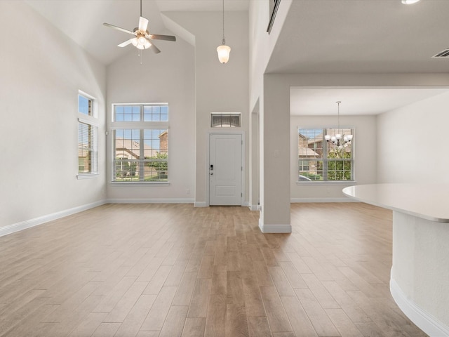 6020 Paddock Ln, Little Elm, TX 76227 - entryway featuring light wood-type flooring, baseboards, a ceiling fan, a chandelier, and high vaulted ceiling