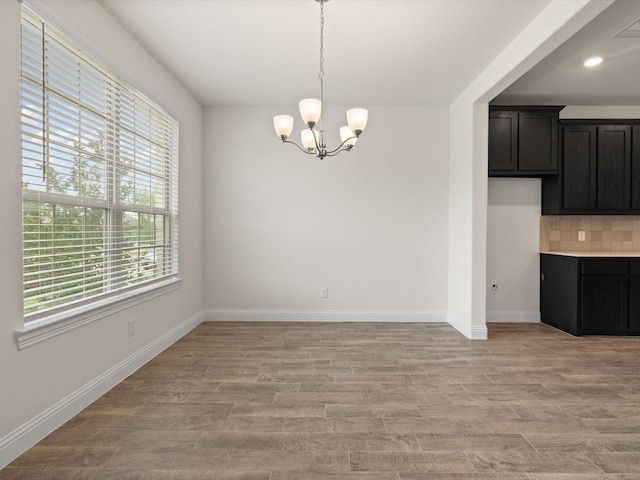 6020 Paddock Ln, Little Elm, TX 76227 - unfurnished dining area with light wood finished floors, a chandelier, baseboards, and recessed lighting