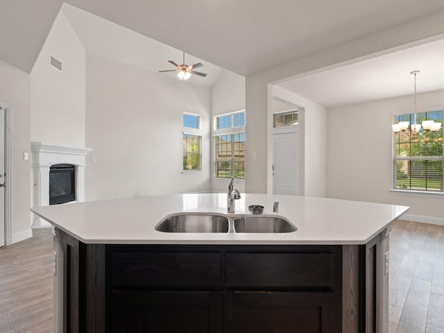 6020 Paddock Ln, Little Elm, TX 76227 - kitchen featuring a sink, light countertops, a kitchen island with sink, healthy amount of natural light, and lofted ceiling