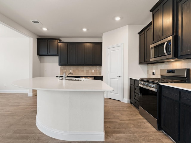 6020 Paddock Ln, Little Elm, TX 76227 - kitchen featuring stainless steel appliances, a sink, backsplash, light countertops, and recessed lighting