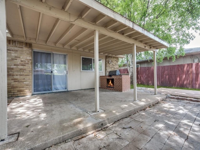 1804 Shreveport Trl, Plano, TX 75023 - view of patio with a warm lit fireplace and fence
