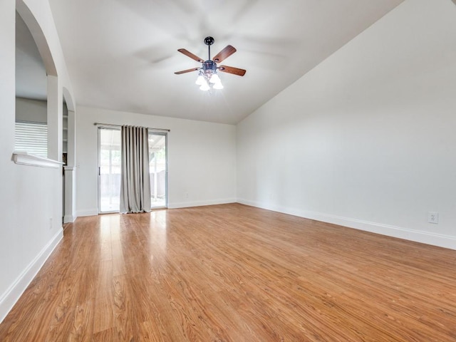 1804 Shreveport Trl, Plano, TX 75023 - empty room with a ceiling fan, arched walkways, light wood-type flooring, lofted ceiling, and baseboards