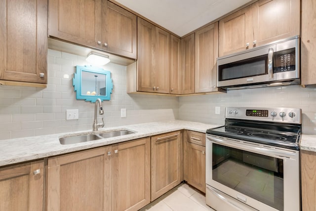 926 Meadowbrook Dr, Grapevine, TX 76051 - kitchen featuring stainless steel appliances, a sink, backsplash, and light stone counters