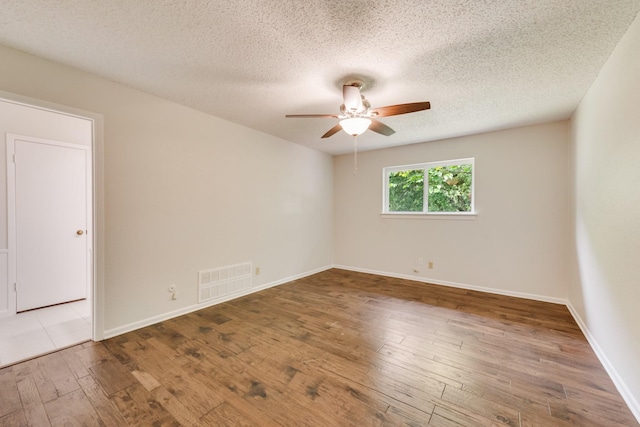 926 Meadowbrook Dr, Grapevine, TX 76051 - unfurnished room featuring a ceiling fan, hardwood / wood-style flooring, a textured ceiling, and baseboards