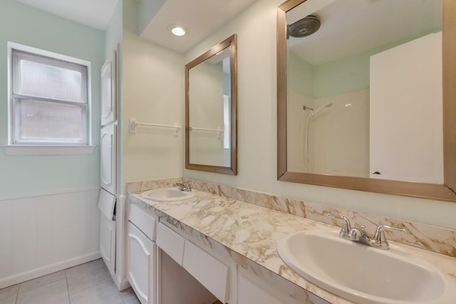 926 Meadowbrook Dr, Grapevine, TX 76051 - bathroom with double vanity, tile patterned floors, a wainscoted wall, and a shower