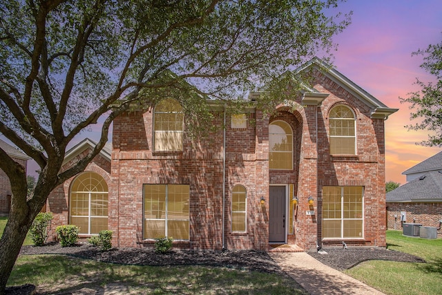 617 Cimmarron Dr, Desoto, TX 75115 - traditional-style house with central AC, brick siding, and a front lawn
