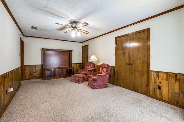 2512 Shadow Lane Dr, Mckinney, TX 75072 - sitting room with wood walls, wainscoting, a ceiling fan, carpet floors, and a textured ceiling
