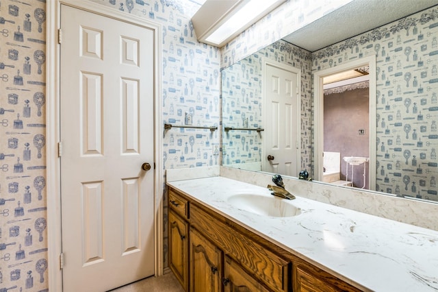 2512 Shadow Lane Dr, Mckinney, TX 75072 - bathroom with wallpapered walls and vanity