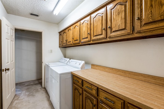 2512 Shadow Lane Dr, Mckinney, TX 75072 - clothes washing area with cabinet space, washer and dryer, light colored carpet, and a textured ceiling