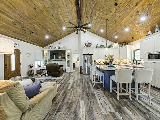 6025 Fm 902, Gainesville, TX 76240 - living room featuring dark wood-type flooring, high vaulted ceiling, wooden ceiling, ceiling fan, and recessed lighting
