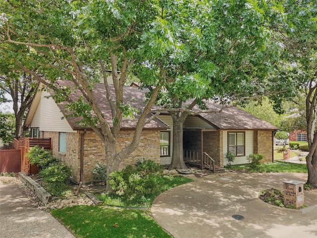 202 Rainbow Cir, Rockwall, TX 75032 - view of front of property featuring brick siding, covered porch, and fence