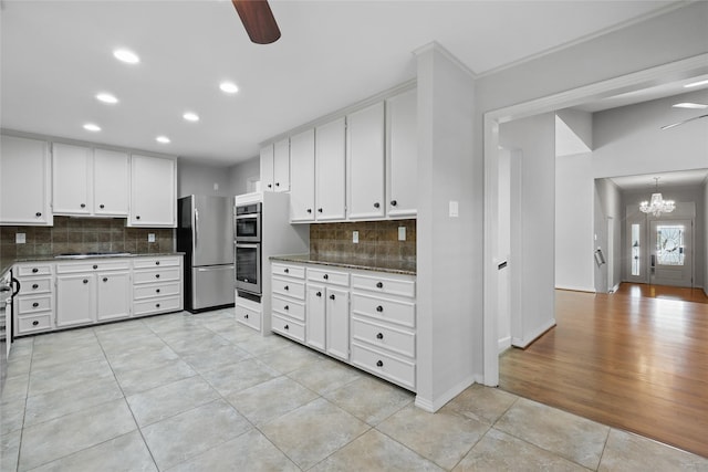 202 Rainbow Cir, Rockwall, TX 75032 - kitchen featuring stainless steel appliances, light tile patterned flooring, recessed lighting, tasteful backsplash, and a chandelier