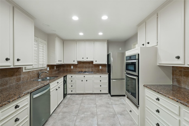 202 Rainbow Cir, Rockwall, TX 75032 - kitchen featuring stainless steel appliances, a sink, backsplash, dark stone counters, and recessed lighting