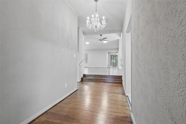 202 Rainbow Cir, Rockwall, TX 75032 - hallway featuring a chandelier, ornamental molding, wood finished floors, a textured wall, and baseboards