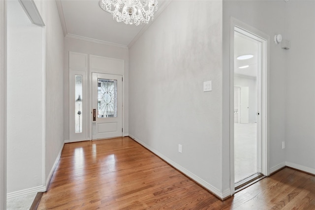 202 Rainbow Cir, Rockwall, TX 75032 - foyer featuring ornamental molding, a chandelier, light wood-style flooring, and baseboards