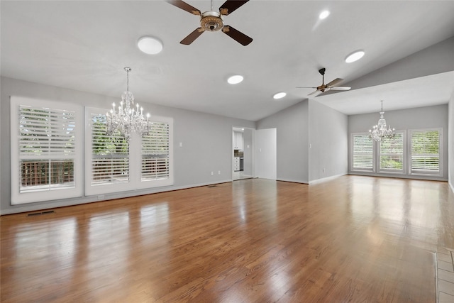 202 Rainbow Cir, Rockwall, TX 75032 - unfurnished living room featuring a chandelier, vaulted ceiling, a ceiling fan, wood finished floors, and baseboards