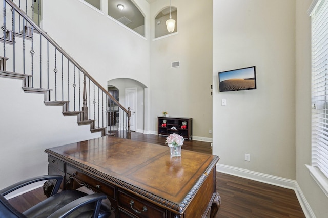15605 Weymouth Dr, Frisco, TX 75036 - office featuring arched walkways, dark wood-style floors, baseboards, and a towering ceiling