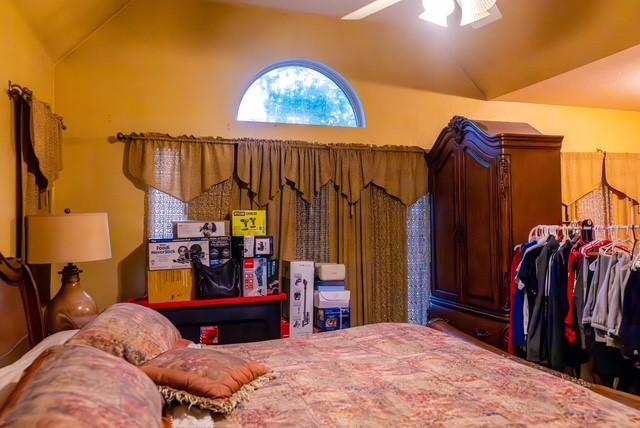 7506 Quail Springs Dr, Arlington, TX 76002 - bedroom featuring lofted ceiling and ceiling fan
