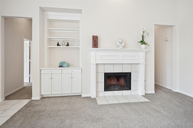 1221 Old Oak Trl, Flower Mound, TX 75028 - living room featuring light carpet, a tiled fireplace, built in shelves, and baseboards