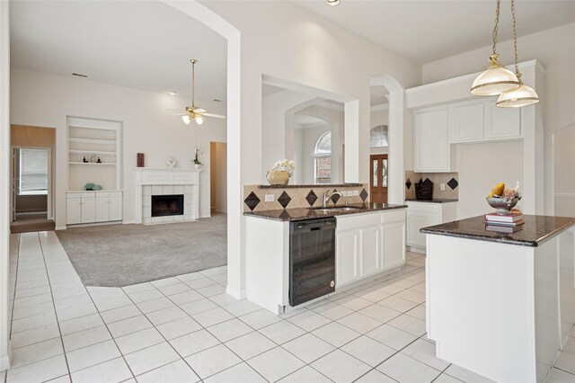 1221 Old Oak Trl, Flower Mound, TX 75028 - kitchen featuring arched walkways, ceiling fan, light tile patterned floors, and built in shelves
