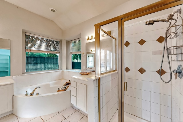 full bath featuring a shower stall, a bath, tile patterned flooring, vaulted ceiling, and vanity