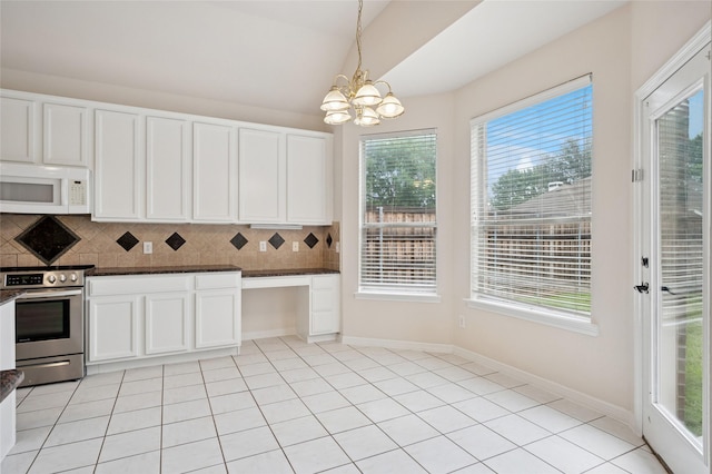 1221 Old Oak Trl, Flower Mound, TX 75028 - kitchen with white microwave, stainless steel range, backsplash, a chandelier, and white cabinetry