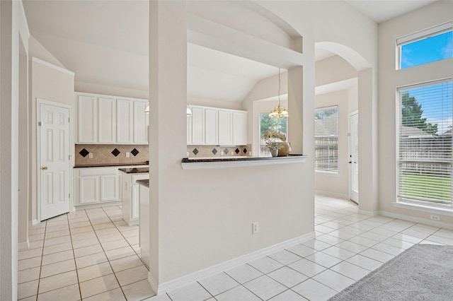 1221 Old Oak Trl, Flower Mound, TX 75028 - hallway featuring light tile patterned flooring, lofted ceiling, healthy amount of natural light, and a chandelier
