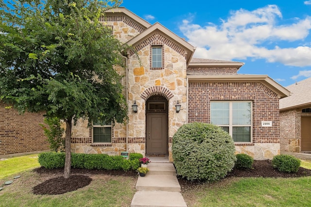 7205 Wildflower Way, Little Elm, TX 76227 - french country style house with stone siding and brick siding