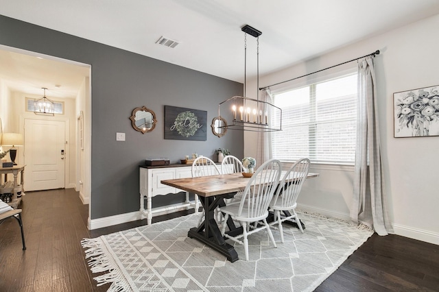 7205 Wildflower Way, Little Elm, TX 76227 - dining area featuring a chandelier, wood finished floors, and baseboards