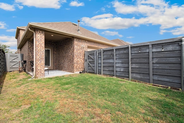 7205 Wildflower Way, Little Elm, TX 76227 - rear view of house with a gate, a patio area, and brick siding