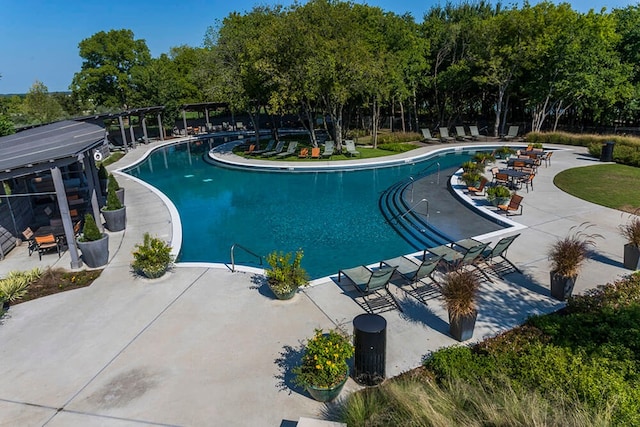 7205 Wildflower Way, Little Elm, TX 76227 - community pool featuring a patio and view of wooded area